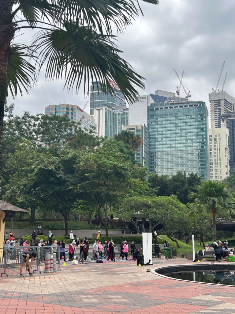 A group of people exercising at KLCC park