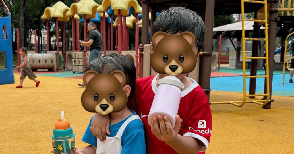 boys drinking water from their bottles at KLCC park playground