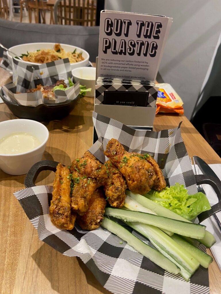 a plate of fried chicken drummettes and wings and cucumber at Ben's KLCC restaurant 