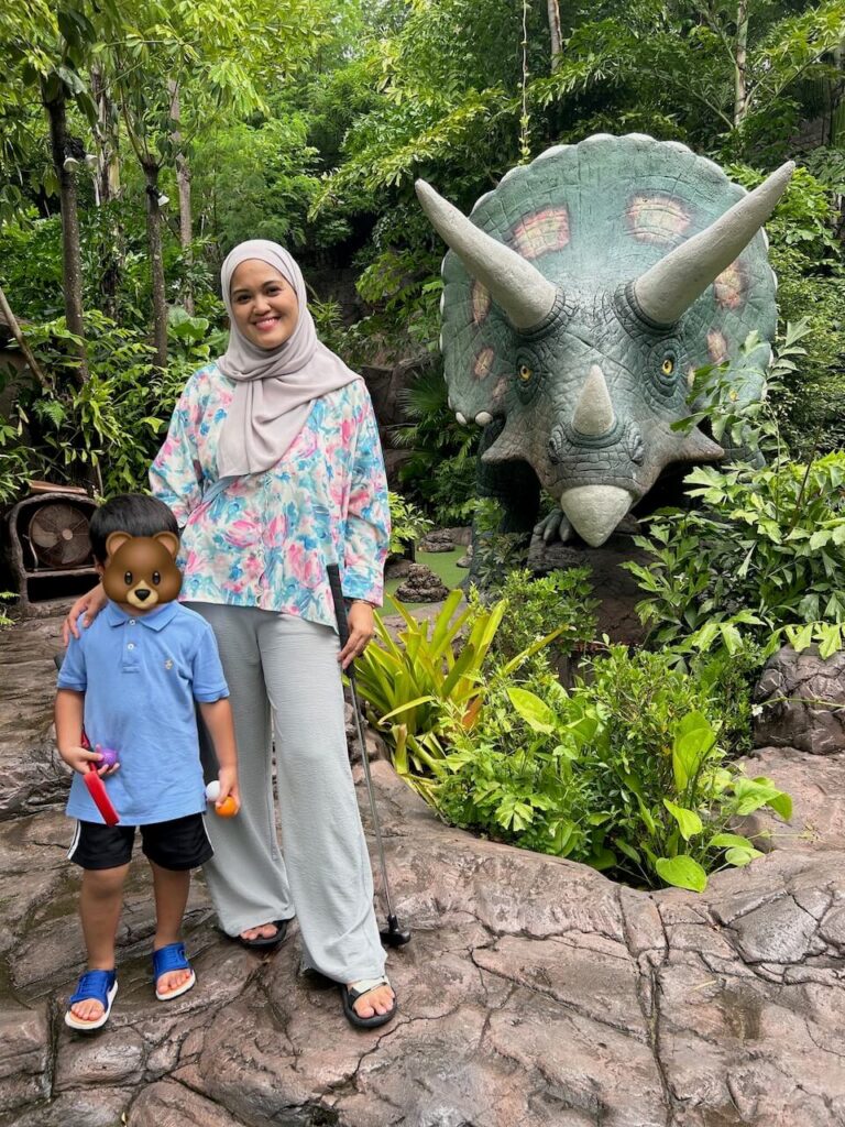 Mom and her son playing mini golf at the Dino Park in Phuket 