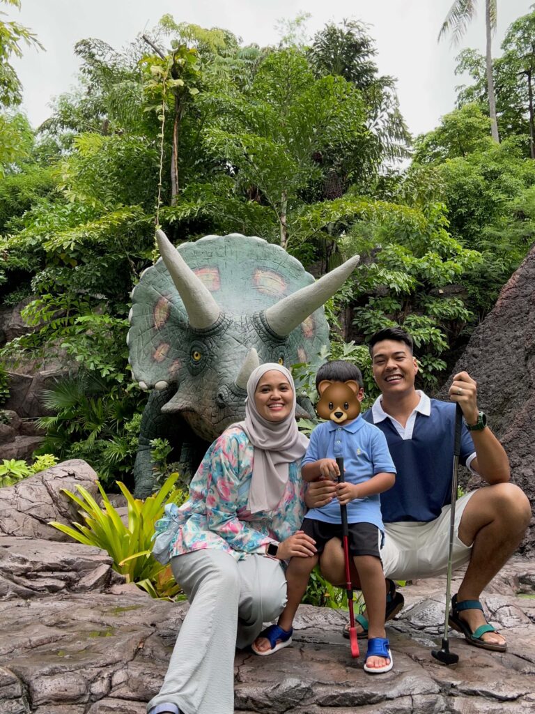 A family of mom, dad, and son, playing mini golf at the Dino Park in Phuket 